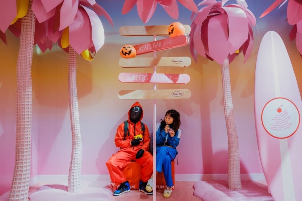 Two friends dressed up in costumes eating ice cream at MUSEUM OF ICE CREAM's Halloween event