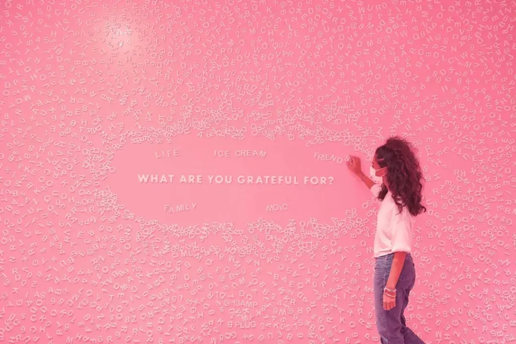 Photo - A photo of a mom at Museum of Ice Cream's magnet wall.