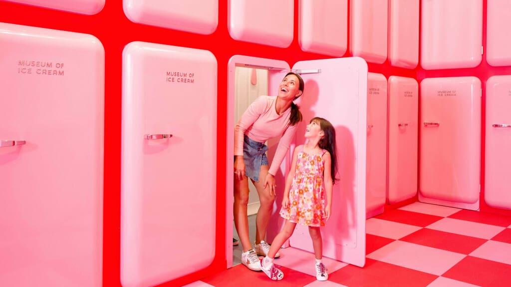 Mother and daughter exploring a pink room at Museum of Ice Cream NYC