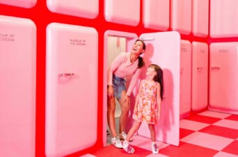 Mother and daughter exploring a pink room at Museum of Ice Cream NYC