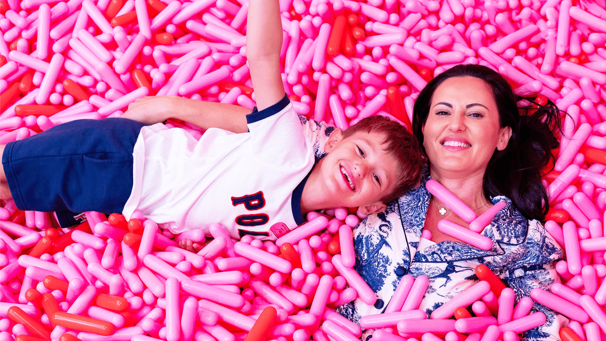 Mom and son enjoying the sprinkle pool at Museum of Ice Cream Boston