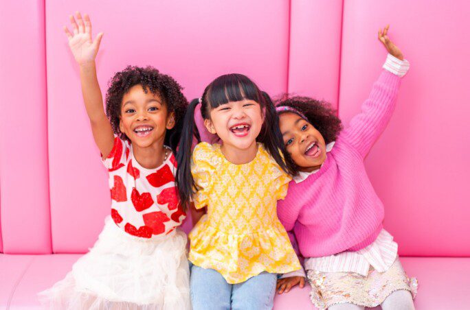 Kids smiling in a pink room at Museum of Ice Cream Chicago