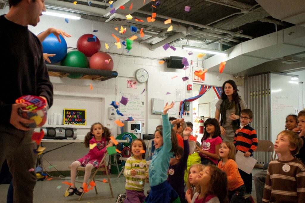 Kids enjoying a confetti activity at 14th Street Y