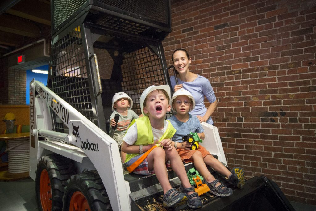 Kids playing on a construction vehicle at Boston Children's Museum
