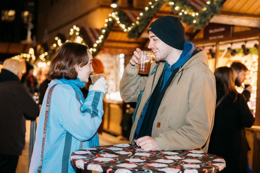 Couple enjoying warm drinks at Christkindlmarket Chicago