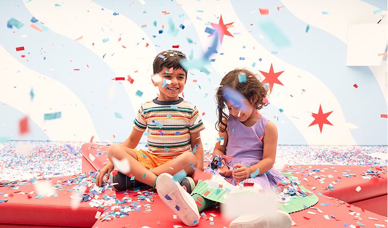 Kids playing in confetti at Color Factory