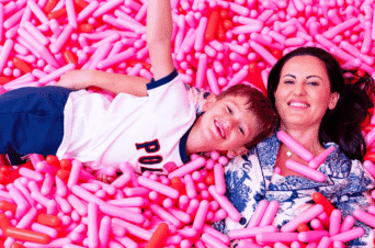 mom and son enjoying the sprinkle pool at Museum of Ice Cream Boston
