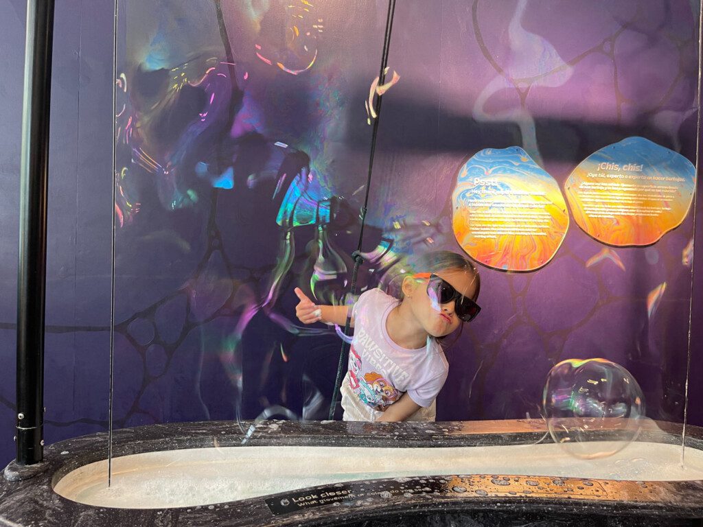 kid playing with bubbles at the New York Hall of Science