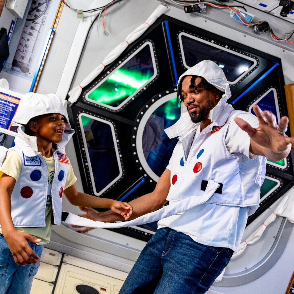 father and son exploring a space exhibit at the Children’s Museum of Indianapolis