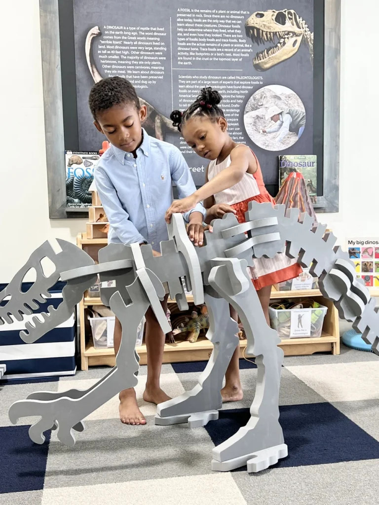 Kids building a dinosaur puzzle at Play Street Museum.
